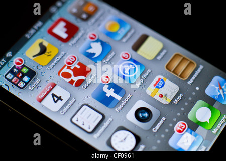 iPhone 4/4S screen showing notifications for various social media apps: Facebook, Twitter, Google+ also for app store, mail Stock Photo