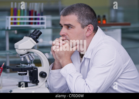 Researcher thinking at his workplace in a laboratory. Stock Photo