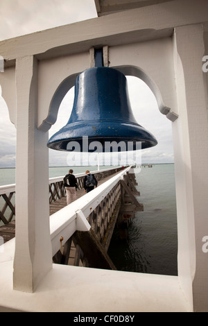 UK, England, Isle of Wight, Yarmouth, blue painted bell at entrance to privately owned pier Stock Photo