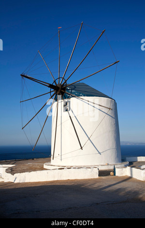 old wind mill which is now converted at a mansion build on the top of a cliff near Artemonas village looking at the sea Stock Photo