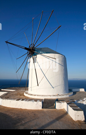 old wind mill which is now converted at a mansion build on the top of a cliff near Artemonas village looking at the sea Stock Photo