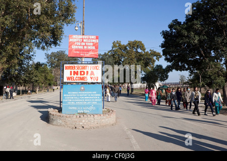 street scene with people walking and welcome to India signs at the Wagah border with Pakistan Stock Photo