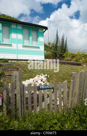 UK, England, Isle of Wight, Bembridge, private sign on gate to colourfully painted beach hut above the Ledges Stock Photo