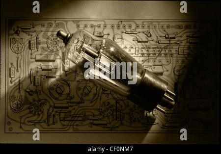 Old style Mullard triode valve sitting on a printed circuit vacuum valves wiring diagram from 1960 Stock Photo