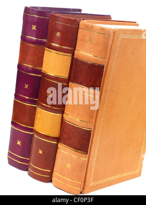 Three hardcover leather bound books on white background Stock Photo