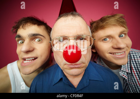 Three men of different age looking at camera, fool’s day celebration Stock Photo
