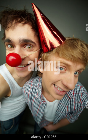 Friends grimacing at camera on fools day Stock Photo