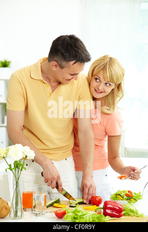 Vertical shot of loving couple cooking healthy food together Stock Photo