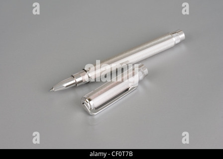 Stylish ballpoint pen of white gold on a grey Stock Photo