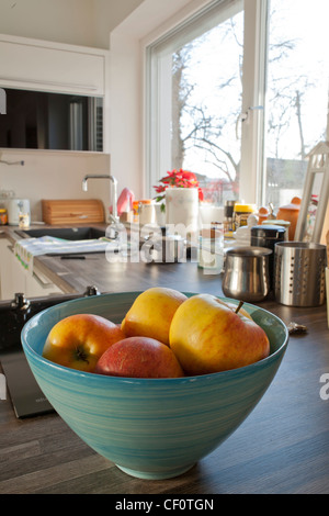 Bowl filled with fruits on the counter in the kitchen. Stock Photo