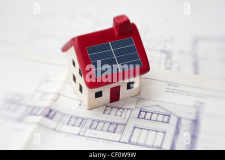 model house with solar panels on architects plans Stock Photo
