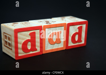 The word 'dad' spelled out in children's building bricks Stock Photo