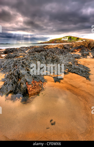 Rays of sun light beaming down over the Beach at Bigbury On Sea and Burgh Island in South Devon. Stock Photo