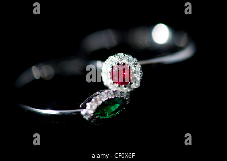 Ruby and emerald ring with diamonds soft focus Stock Photo