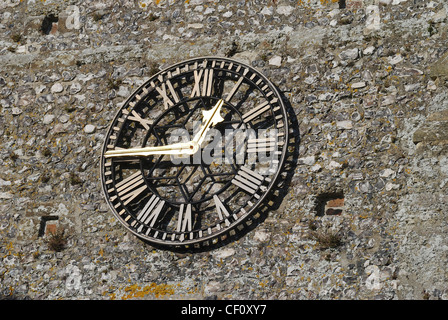 Clock on flintstone tower to Saint Mary the Virgin Church at Burpham. West Sussex. England Stock Photo