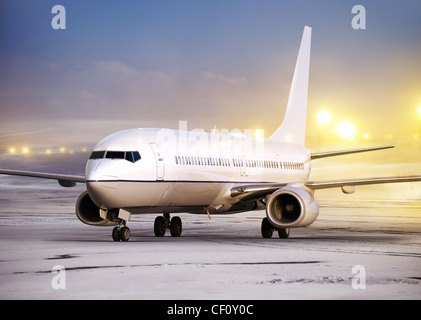 airport and white plane at non-flying weather, winter time Stock Photo