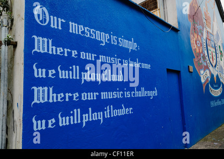 Message on East Belfast Mural 'Where our music is welcome we will play it loud. Where it is challenged we will play it louder' Stock Photo