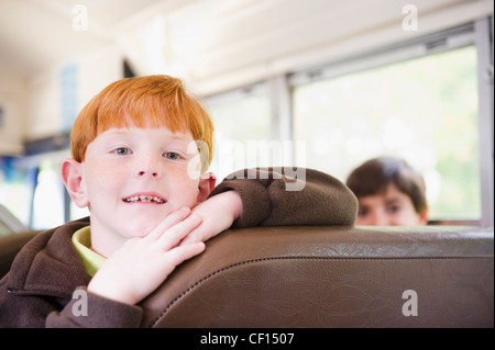 Children riding school bus Stock Photo