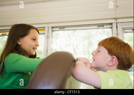 Children riding school bus Stock Photo