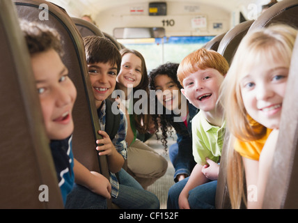 Children riding school bus Stock Photo