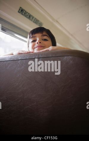 Caucasian boy riding school bus Stock Photo