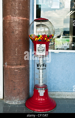 delightful old fashioned red retro gumball gum ball machine installed in loggia of shopping mall Oaxaca de Juarez Mexico