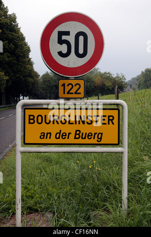 Typical town name sign with speed limit warning (50km/h) upon the entrance to the town of Bourglinster, Luxembourg. Stock Photo