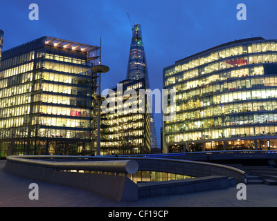 More London Riverside offices illuminated at twilight with lights on
