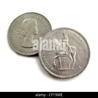 A British  jubilee crown coin of Queen Elizabeth II in the foreground with another crown showing her profile as a young queen. Stock Photo