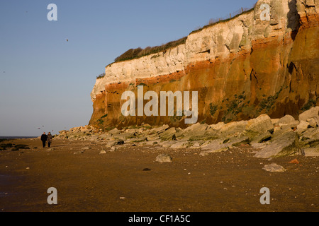 Cliffs made of red and white layered sedimentary rock with horizontal strata in Hunstanton, Norfolk Stock Photo