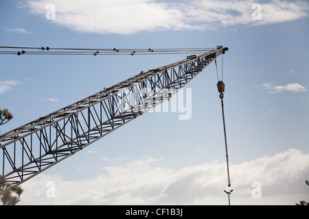 A large heavy lifting crane against a cloudy sky. Stock Photo