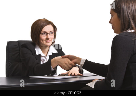 Businesswomen shaking hands in the office. Stock Photo