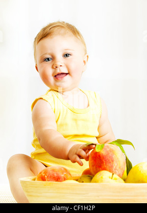 Little baby choosing fruits, closeup portrait, concept of health care & healthy child nutrition Stock Photo