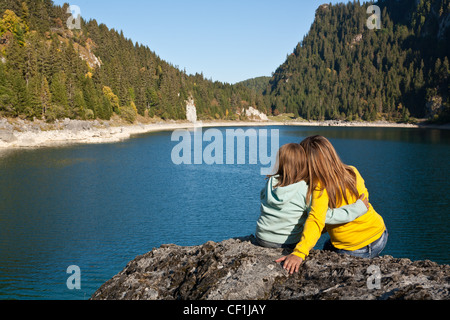 Little girl and her mom sharing a moment of tenderness at the Tanney lakeside Stock Photo