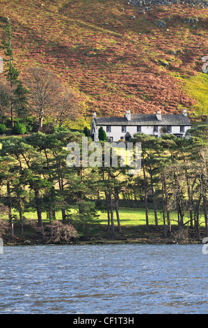 Row of white  terraced Lakeland cottages taken from Ullswater Lake during winter, Cumbria, England, UK Stock Photo