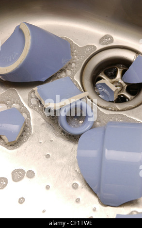 Detail of broken blue cup in stainless steel sink Stock Photo