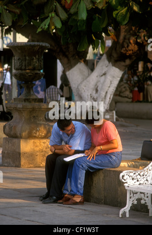 Mexicans Mexican people person man and woman couple sitting in plaza along The Malecon seaside promenade Puerto Vallarta Mexico Stock Photo