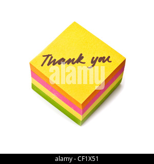 Thank you note written on a sticky note pad isolated on a white studio background. Stock Photo