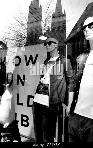 Refection of newly restored Truro Cathedral in River Island Shop window, with a  'WOW' sign and mannequins wearing sunglasses Stock Photo