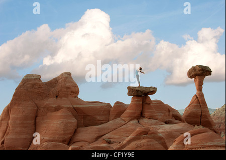 Caucasian woman practicing yoga on top of rock formation Stock Photo