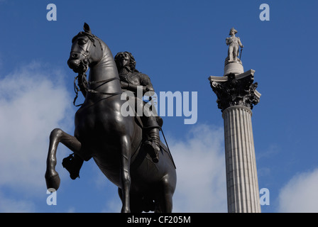 Looking up at a bronze statue of King Charles I and Nelson's Column in Trafalgar Square. The statue of King Charles I (1625-1649