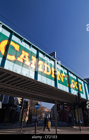 The old railway bridge over Chalk Farm Road at Camden Lock. The bridge features a 'trompe l'oeil' image which has become the ico Stock Photo