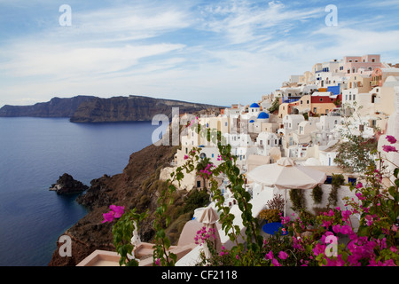 A view of the village of Oia perched on the cliff top above the caldera of Santorini Stock Photo