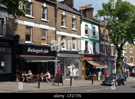 People sitting outside a Patisserie and cafe in Tranquil Vale, Blackheath, on a warm spring afternoon. Stock Photo