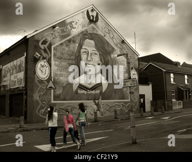 Bobby Sands mural painted on the side of Sinn Fein office on the Falls Road in West Belfast, Northern Ireland,photographed with a moody dark treatment Stock Photo