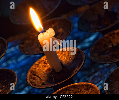 Burning candle in St Mary's Church, Great Budworth, Near Northwich and Antrobus , Cheshire England, United Kingdom Stock Photo