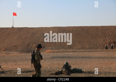 Afghan National Army commandos from the 3rd Commando Kandak participate in weapons training on a range in Kandahar district, Kandahar province, Afghanistan on Feb. 25. The commandos, partnered with coalition Special Operation Forces, practice weapons safety and rifle marksmanship to be better prepared to defend the people of Afghanistan Stock Photo