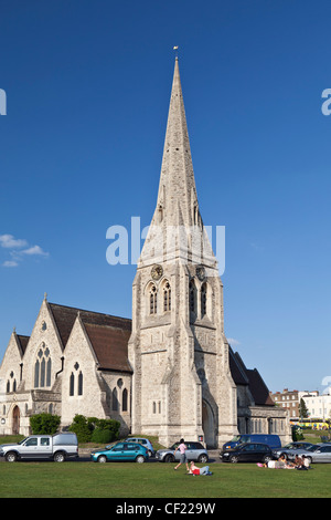 People relaxing on Blackheath in front of All Saints' Church. Stock Photo