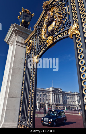 A black London taxi cab travelling past Buckingham Palace. Stock Photo