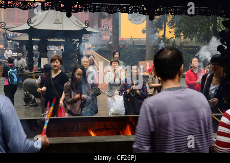 Crowds praying for blessings with incense sticks at the Ling Yin Buddhist temple Hangzhou China Stock Photo